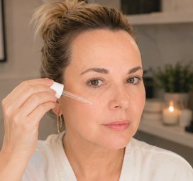 Liz applying serum with a dropper