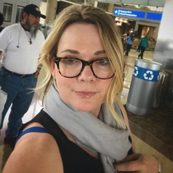 Liz at the airport wearing a scarf